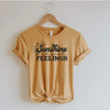 Sunshine And Good Feelings retro tee in mustard yellow with black lettering